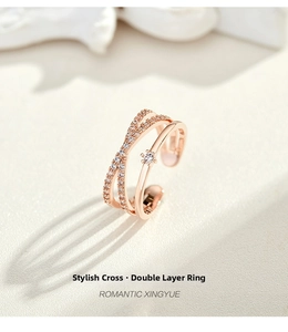 Close-up of rose gold double-layer crisscross ring with pavé zircons and a round center stone