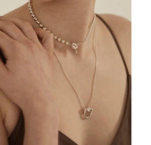 Layered 925 sterling silver box necklaces with horseshoe pendant shown on model