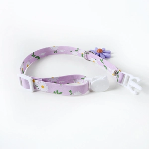 Close-up of adjustable purple daisy pet collar with cute cat-shaped safety buckle