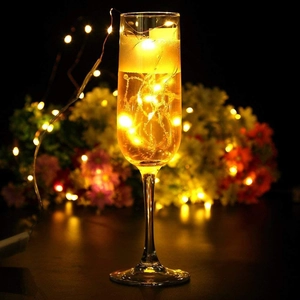 Warm white LED copper string lights in a champagne glass for festive decoration