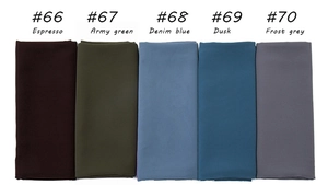 Flat lay of multiple pearl chiffon hijabs in dark coffee, army green, and dusk blue colors