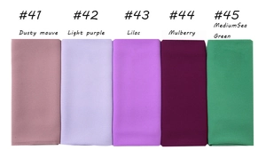 Flat lay of chiffon headscarf fabrics in purple, berry, and sea green shades