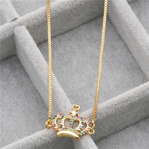 Macro shot of crown pendant with colorful zircons in a soft grey velvet jewelry box