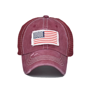Detail view of washed burgundy baseball cap with vintage flag embroidery and mesh