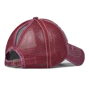 Detail view of burgundy washed cotton baseball cap with ponytail hole and metal buckle