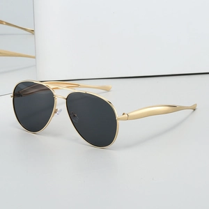 Classic gold metal aviator sunglasses with dark lenses on a minimalist white pedestal