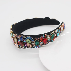 Macro shot of Baroque padded headband with multi-color crystal gemstones on black velvet