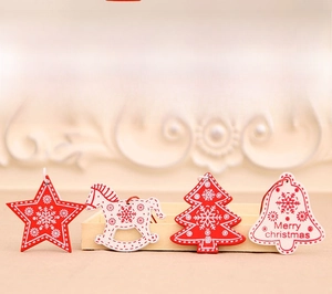 Detailed view of red and white wooden Christmas ornaments with festive star and bell designs