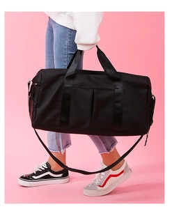 Detail of multi-functional black sports bag showing waterproof material and durable handles