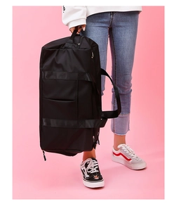 Close-up of black sports bag with separate shoe compartment and nylon fabric texture