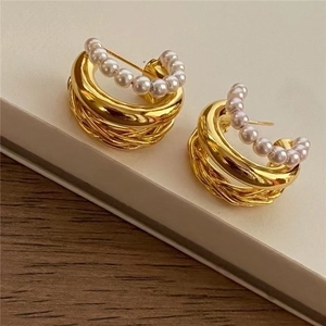 Detail of 18K gold plated multi-layer pearl earrings featuring high-gloss finish