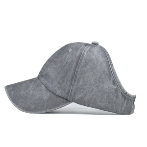 Side view of gray washed cotton ponytail baseball cap with back opening and decorative stitching