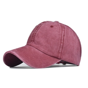Detail view of burgundy ponytail baseball cap with breathable eyelets and vintage canvas texture