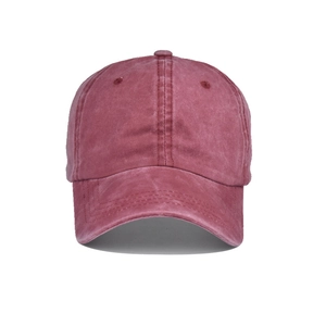 Detail of vintage washed burgundy ponytail baseball cap with distressed cotton canvas texture