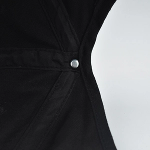 Detail view of the black cotton baseball cap interior featuring reinforced stitching and metal rivet