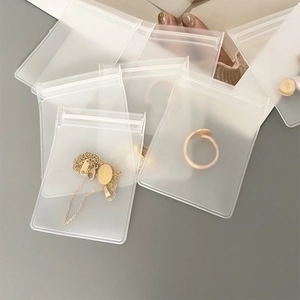 Detailed view of clear EVA jewelry storage bags with secure zipper for earrings and rings