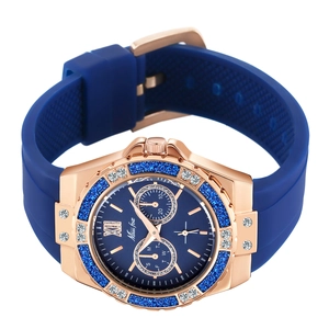 Detail of rose gold women's watch with blue silicone strap and diamond-encrusted bezel
