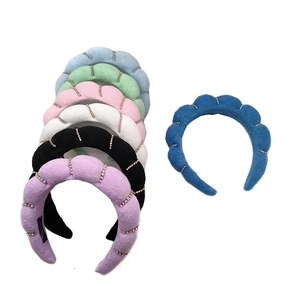 Padded velvet knot headbands with rhinestone accents in assorted pastel and dark colors