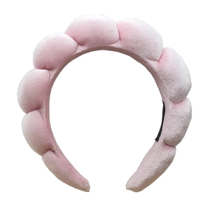 Close-up of pink velvet braided headband showing soft texture and padded design