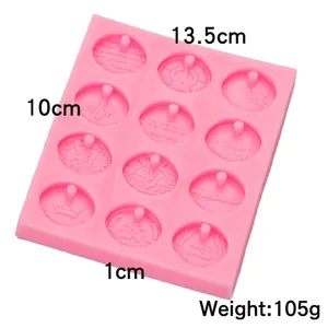 Pink 12-cavity silicone mold with coin relief patterns for soap and wax pendants