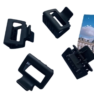 Set of four matte black square hair claw clips with smooth frosted finish for women