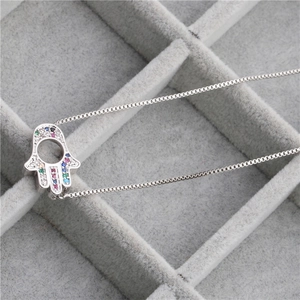 Silver Hamsa Hand Necklace with colorful zircon stones in a velvet display box
