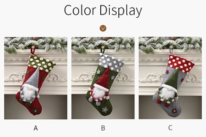 Three 20-inch Christmas stockings with gnome plush decor in red, green and grey colors