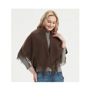 Close-up of soft deep brown knitted shawl with tassel fringe details for winter fashion