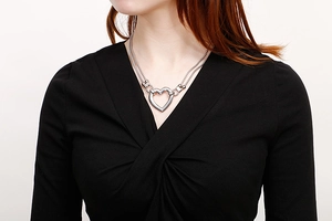 Close-up of double layer stainless steel heart necklace worn by a fashion model