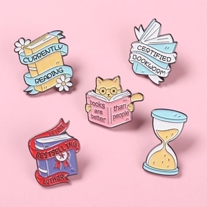 5-piece enamel book pin set featuring reading cats and floral designs on pink background