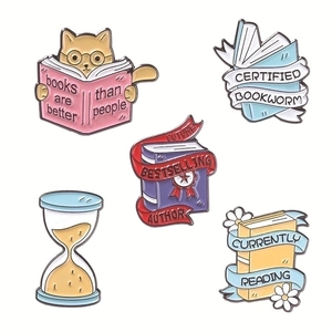 5-piece literary enamel pin set with cat reading books and author medals on white background