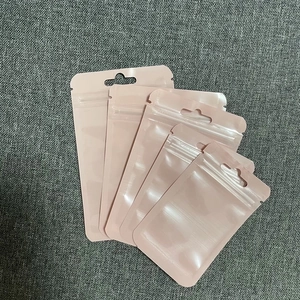 Close-up of four pink resealable plastic pouches with zipper closure and hanging hole