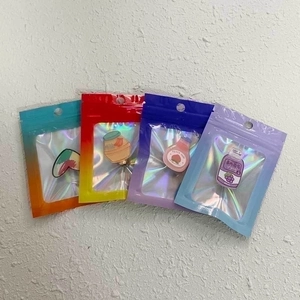 Holographic gradient resealable bags for jewelry with colorful enamel pins inside