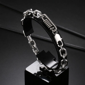 Industrial style stainless steel link bracelet with spring detail and lobster clasp on stand