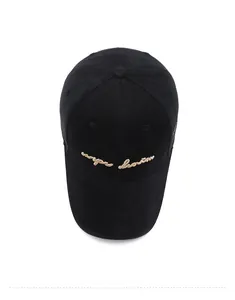Top view of a black cotton baseball cap with gold embroidery and ventilation eyelets
