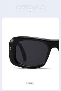 Close-up of chunky square black sunglasses featuring silver hourglass metal rivets