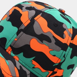 Macro shot of colorful camouflage cotton fabric and stitched panels on baseball cap