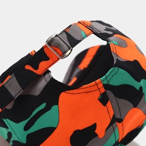 Detail of camouflage baseball cap showing the adjustable metal buckle and durable fabric