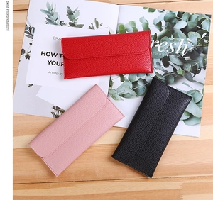 Leather envelope wallets in red, pink, and black featuring classic litchi grain texture