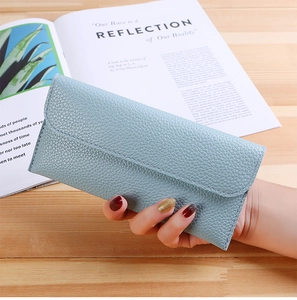 Close-up of a light blue lychee-textured leather long wallet in an envelope style