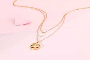 Detail view of gold double-layer necklace with Mom letter pendant for Mother's Day