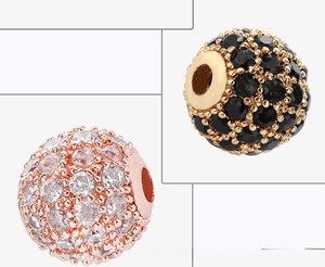 Detailed view of 8mm copper micro-pave zircon beads in rose gold and gold finishes