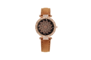Detailed macro view of a rose gold watch face with sparkling floral rhinestone patterns