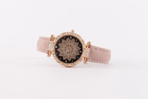 Detail of rose gold watch with black diamond floral dial and pink suede strap