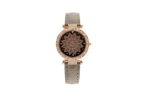 Macro detail of rose gold watch case with starry dial and hollow petal pattern