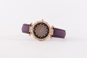 Detail of rose gold watch case with sparkling rhinestones and purple leather strap