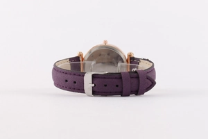 Detail showing the stainless steel back cover and purple leather strap of the watch