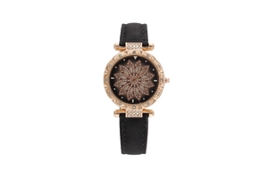 Detail of rose gold starry watch with crystal lotus dial and black leather strap