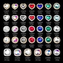 Macro shot of assorted multi-shape nail art rhinestones with gold and silver metal borders
