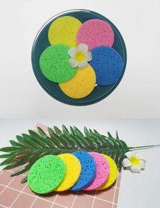 Macro detail of colorful round wood pulp facial sponges for deep cleansing and exfoliation